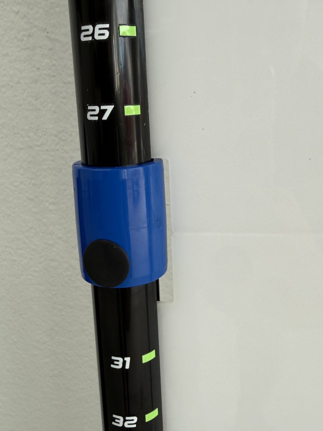 Measurement markings in inches on the frame with a blue collar